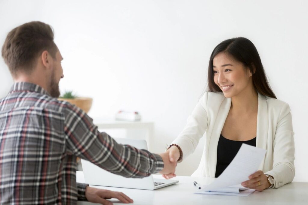 Two people shaking hands in agreement.